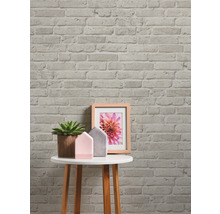 Papier peint décoratif en briques avec table d''appoint, plante et cadre photo