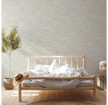 Chambre lumineuse avec papier peint en briques, lit en bois et plante d''intérieur