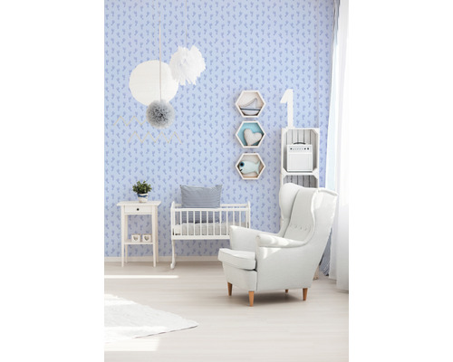 Chambre de bébé avec lit, fauteuil et revêtement mural à motifs