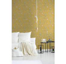 Schlafzimmer mit gelber gemusterter Tapete, Bett und Nachttischen.