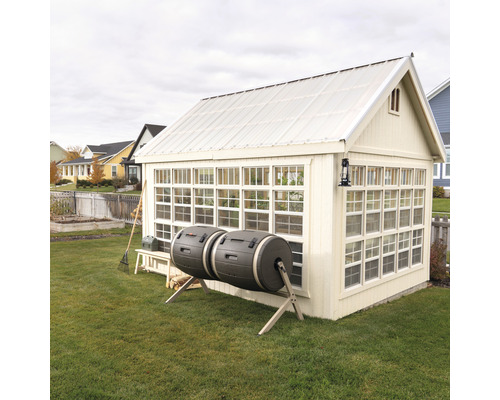 Serre avec composteurs à tambour dans le jardin