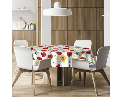 Esstisch mit rundem Tischtuch mit Mohnblumen und Sonnenblumenmuster in einer modernen Küche.