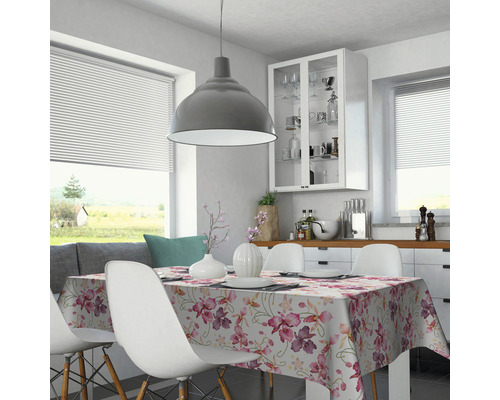 Esstisch mit blumengemusterter Tischdecke in heller, freundlicher Küche