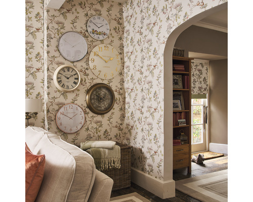 Séjour avec papier peint à motifs floraux et collection d''horloges murales de différents modèles