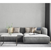 Wohnzimmer-Szene mit grauem Ecksofa, Kissen, Beistelltisch und Dekoration