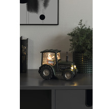 Tracteur décoratif à boule à neige avec le Père Noël sur une armoire