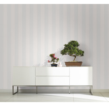 Einrichtungsidee mit gestreifter Tapete und Sideboard mit Bonsai Pflanzen