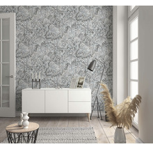 Espace de vie avec buffet blanc et papier peint gris à motif de plantes