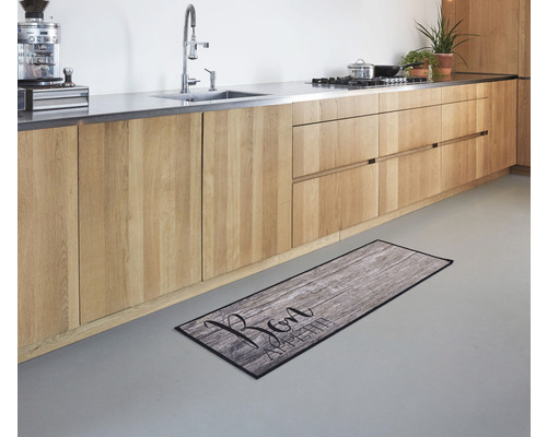 Scène de cuisine avec tapis de cuisine aspect bois et inscription Bon Appetit