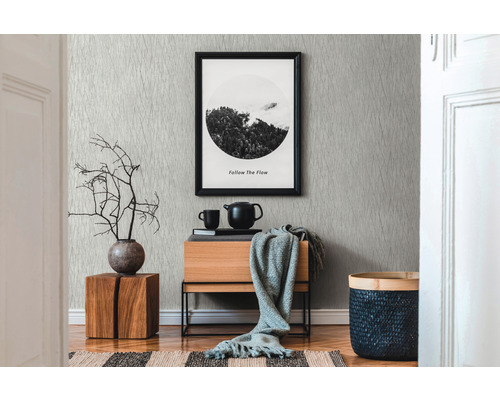 Espace de vie avec papier peint à motifs, commode en bois et éléments décoratifs