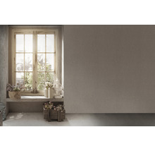 Helles Zimmer mit Fenster, Blumenarrangements und leerer Wand