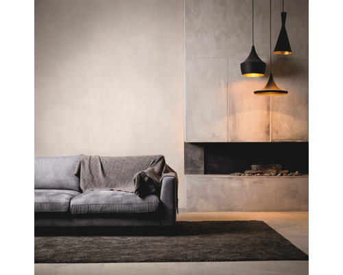 Wohnzimmer mit Sofa, Teppich, Kamin und drei Pendelleuchten