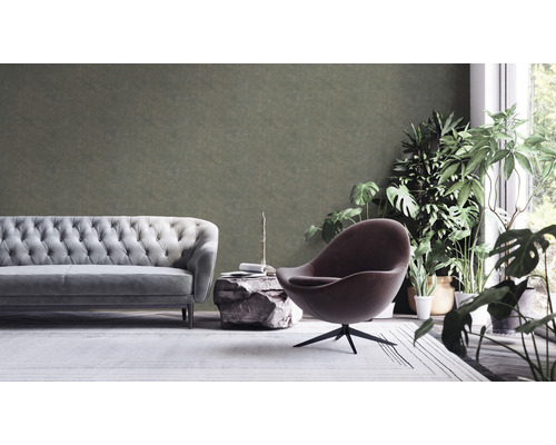 Wohnzimmer mit Sofa, Sessel, Steintisch und Zimmerpflanzen