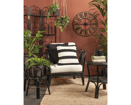 Salon avec fauteuil en rotin, table d''appoint, paravent, horloge murale et plantes d''intérieur pour une ambiance chaleureuse