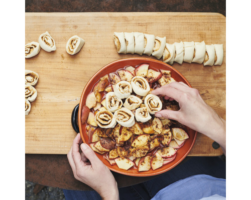 Zubereitung von Apfel-Zimtschnecken auf einem Holzbrett