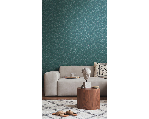 Wohnzimmer mit gemusterter Tapete, Sofa und Beistelltisch