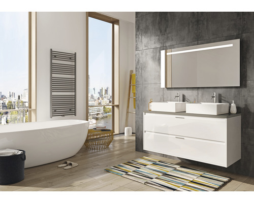 Helles Badezimmer mit Badewanne, Waschtisch mit zwei Waschbecken und beheiztem Handtuchhalter