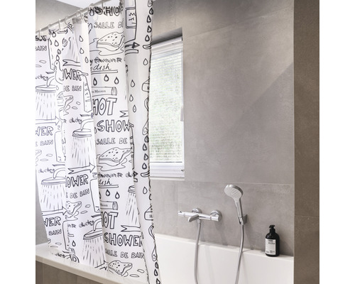 Badezimmer mit Badewanne und Duschvorhang mit grafischem Muster