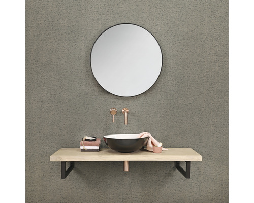 Salle de bains avec miroir rond, lavabo à poser, plan de toilette et robinetterie