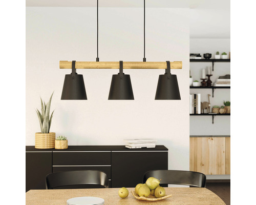 Hängelampe mit drei Leuchten und Holzdetail über einem Esstisch