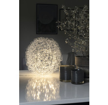 Dekorative Kugel-Tischleuchte mit Drahtgeflecht und LED-Lichtern auf einem Tisch