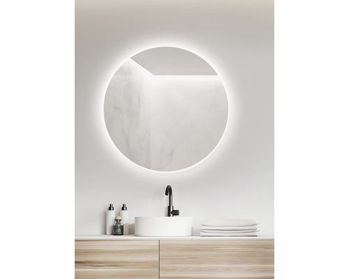 Salle de bains avec miroir rond, lavabo et meuble-lavabo