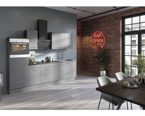 Cuisine moderne avec four intégré, hotte aspirante et armoires de cuisine dans une pièce avec une table à manger
