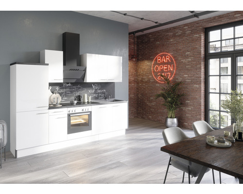 Cuisine claire avec armoires blanches, plan de travail foncé et coin repas