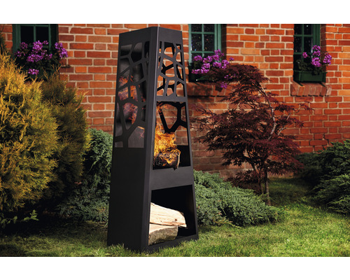 Cheminée d''extérieur noire avec rangement pour le bois dans le jardin