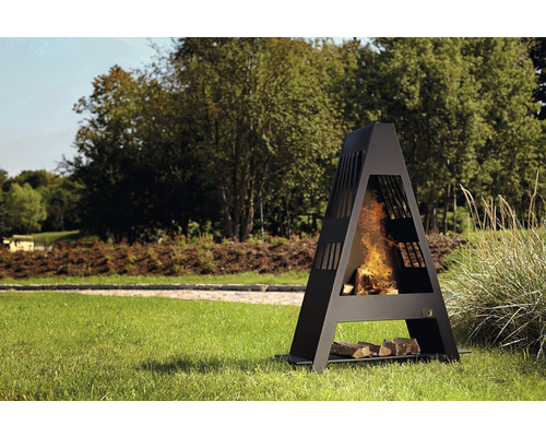 Foyer en acier dans le jardin avec du bois qui brûle