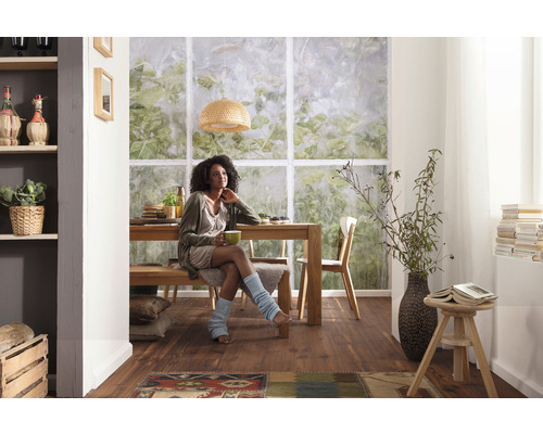 Salle à manger lumineuse avec table en bois, banc, chaises et une femme.