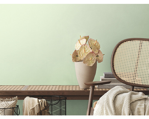 Pièce décorative avec banc en bois, anthuriums, fauteuil en rotin et accessoires d''intérieur