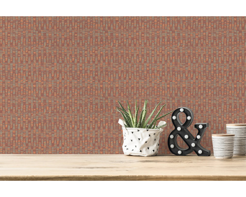 Gros plan d''un mur avec un papier peint à motifs rectilignes, décoré d''une plante d''intérieur, d''une esperluette lumineuse et de deux gobelets sur une surface en bois.