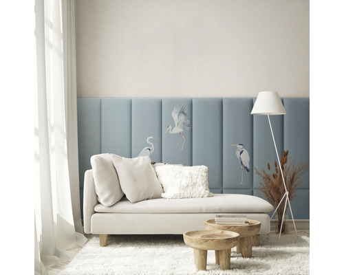 Wohnzimmer mit Couch, Kissen, Beistelltischen, Stehlampe und Wandpaneelen mit Vogelmotiven für eine helle und organisierte Atmosphäre.