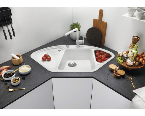 Eckspüle mit Armatur, Abtropffläche und Gemüsebehälter in einer modernen Küche.