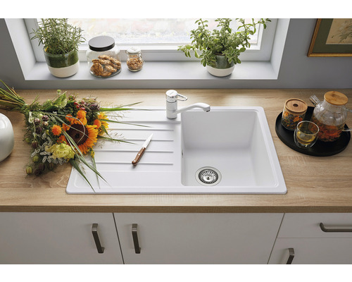 Küchenspüle mit Abtropffläche und Armatur auf einer Küchenarbeitsplatte