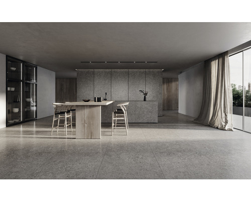 Heller Raum mit Steinfliesen, Holztisch und Stühlen sowie Küchenschrank