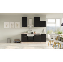 Cuisine moderne avec armoires noires, hotte aspirante et coin repas