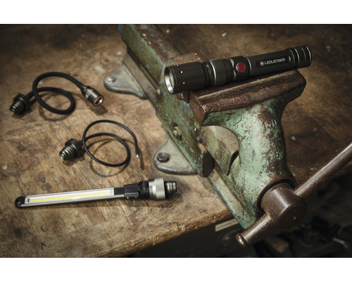 Lampe de poche Ledlenser et accessoires sur établi