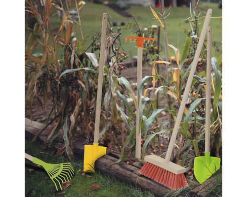 Outils de jardin tels que râteaux, balais et pelles dans le parterre