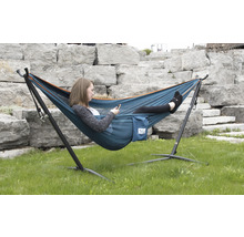 Femme se détend dans un hamac avec support dans le jardin.