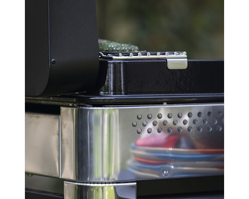 Vue détaillée d''un gril noir avec espace de rangement en métal