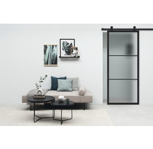 Salon avec porte coulissante, canapé, tables basses et décoration murale pour une ambiance élégante