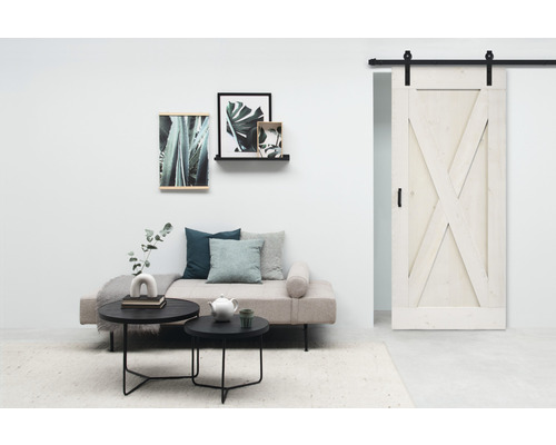 Wohnzimmer mit Schiebetür im Scheunenstil, Sofa, Couchtischen und Wanddekoration