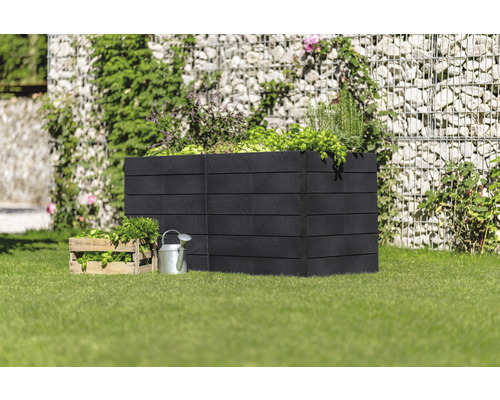 Jardinière surélevée en bois avec herbes aromatiques et légumes dans le jardin