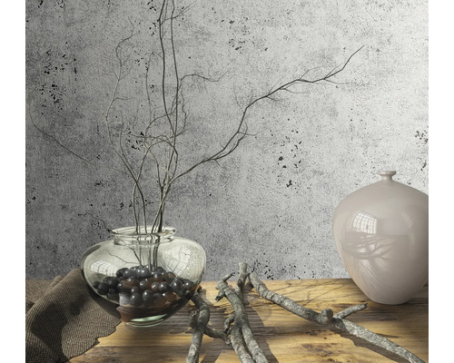Scène décorative avec un vase en verre, des branches et un vase en céramique sur une table en bois