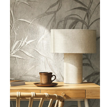 Mur décoratif avec motif de feuilles, lampe de bureau et tasse à thé pour une ambiance chaleureuse