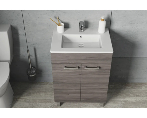 Meuble sous-vasque avec lavabo et robinet dans une salle de bains.