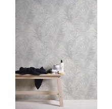 Raum mit Tapete mit Palmenblattmuster und Holzhocker