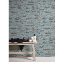 Vue d''une pièce avec papier peint à motifs, tabouret en bois clair et accessoires de salle de bain